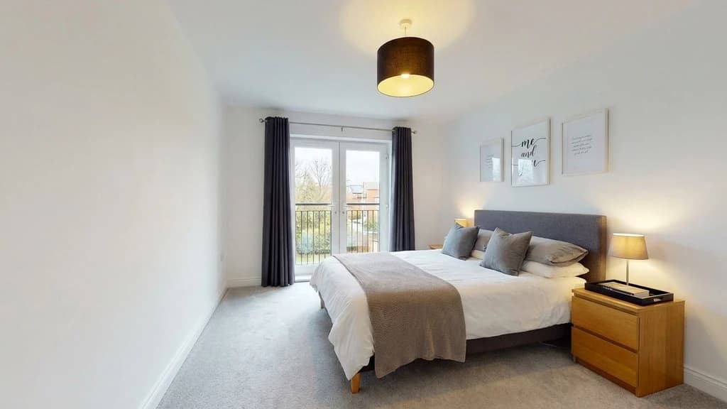 Before-and-after comparison of a bedroom enhanced with Styldod's AI noise reduction tool to remove grain while preserving natural detail.